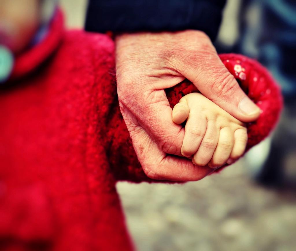 Family budgeting worksheet with pen and calculator on wooden table
